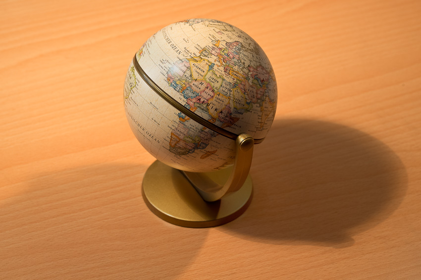 Photo of a toy globe and cross shadows